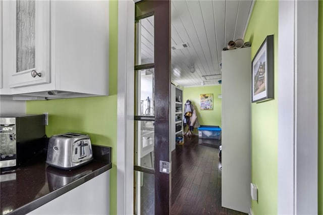 kitchen featuring white cabinets and dark wood-type flooring