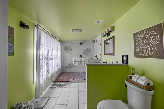 bathroom featuring tile patterned floors, a shower, vanity, and toilet