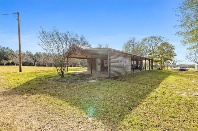 view of side of home featuring a carport and a lawn