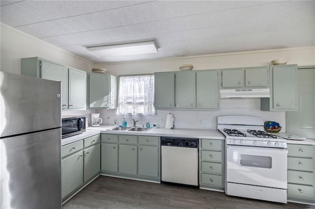 kitchen featuring sink, stainless steel appliances, dark hardwood / wood-style floors, and ornamental molding