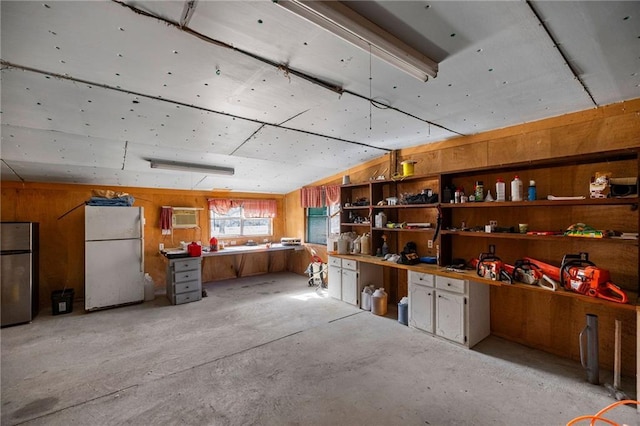 interior space featuring a wall unit AC, a workshop area, and wooden walls