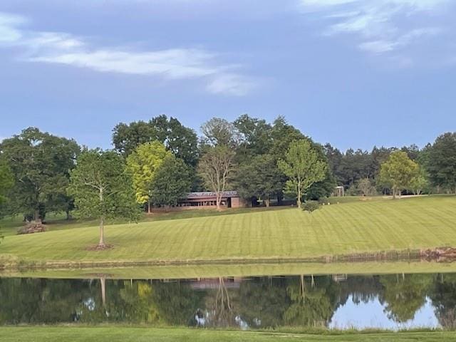 surrounding community with a yard and a water view