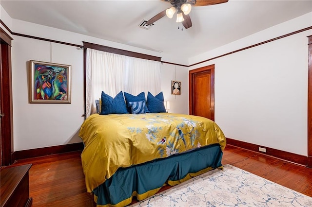 bedroom featuring ceiling fan and dark hardwood / wood-style flooring