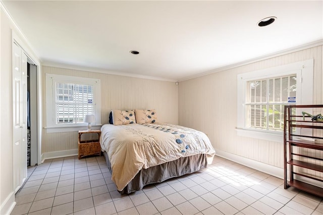 bedroom with light tile patterned floors and ornamental molding