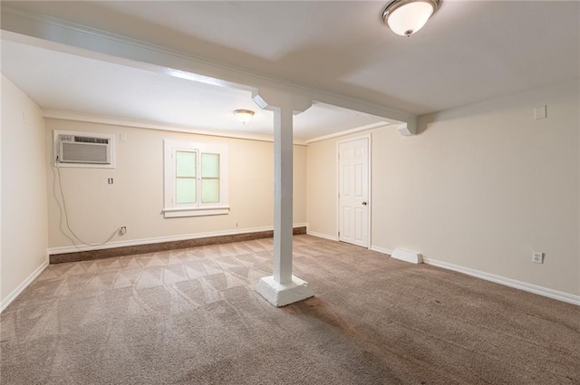 basement featuring light colored carpet, crown molding, and a wall unit AC