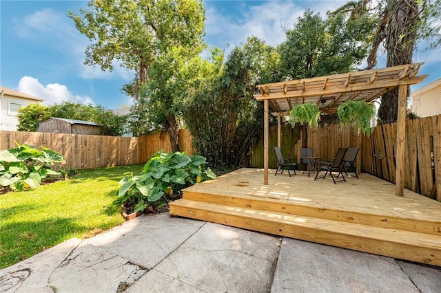 deck with a yard and a pergola