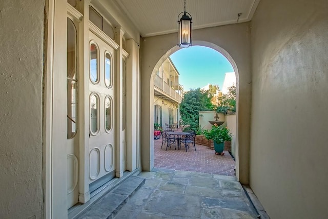 view of exterior entry with a patio