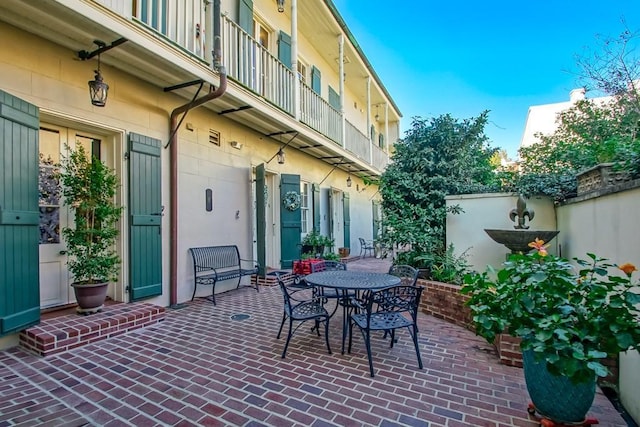 view of patio featuring a balcony