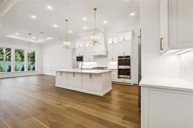 kitchen with pendant lighting, white cabinets, stainless steel appliances, and dark hardwood / wood-style floors