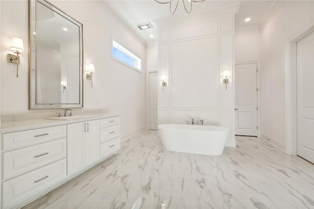 bathroom featuring ornamental molding, vanity, and a bathing tub