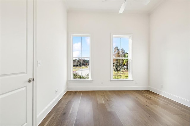 unfurnished room featuring hardwood / wood-style floors, ceiling fan, and crown molding