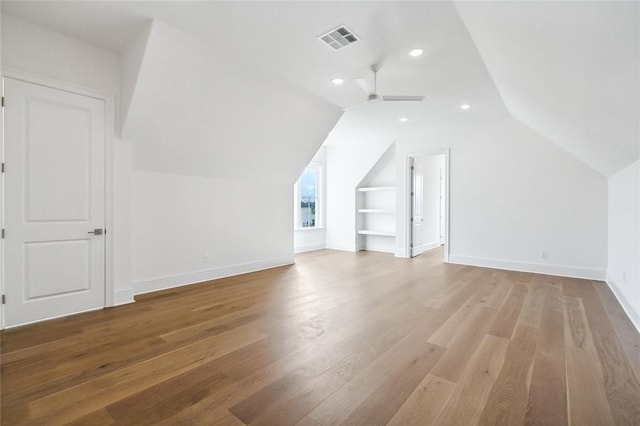 bonus room featuring hardwood / wood-style floors, ceiling fan, and vaulted ceiling