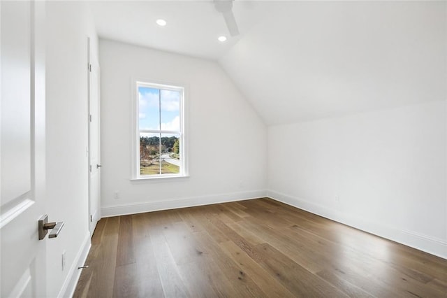 bonus room with vaulted ceiling and hardwood / wood-style flooring