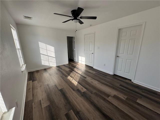 unfurnished bedroom featuring ceiling fan and dark wood-type flooring