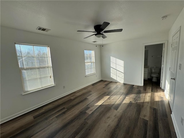 unfurnished room with dark hardwood / wood-style floors and ceiling fan