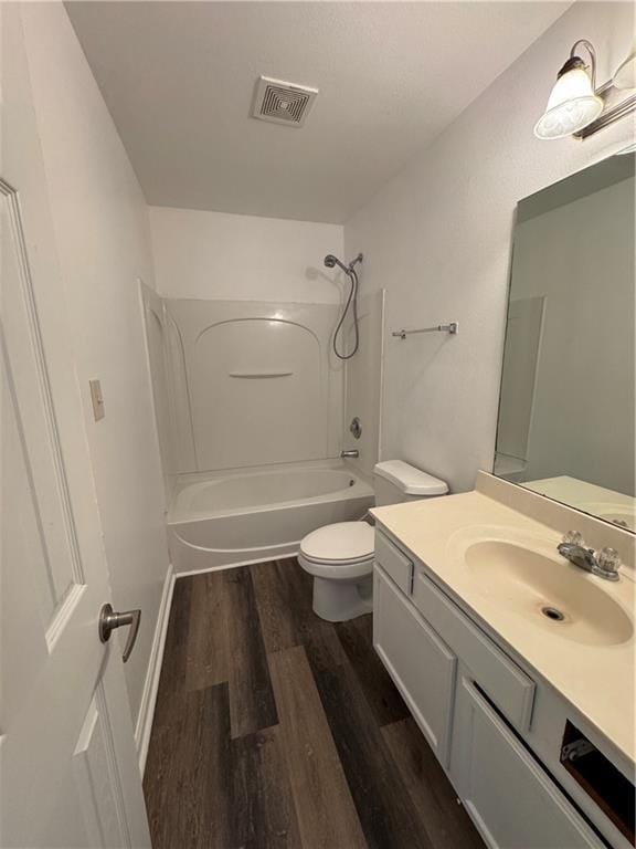 full bathroom with hardwood / wood-style flooring, vanity, toilet, and shower / bath combination