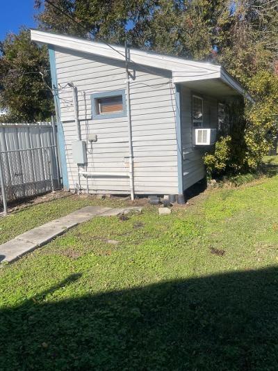 view of side of home with a lawn