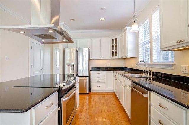 5913 Catina St, New Orleans, LA 70124 - kitchen with island range hood, appliances with stainless steel finishes, ornamental molding, white cabinets, and light wood-style floors