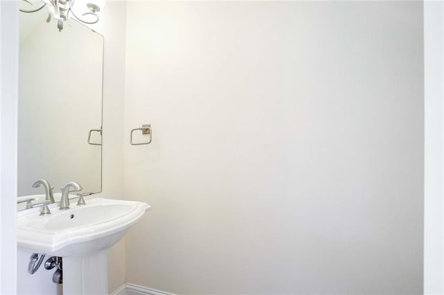 5913 Catina St, New Orleans, LA 70124 - bathroom featuring baseboards and a sink