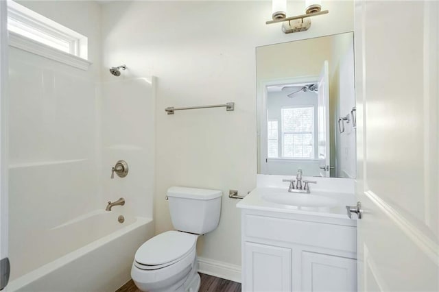 full bathroom featuring ceiling fan, tub / shower combination, hardwood / wood-style floors, toilet, and vanity