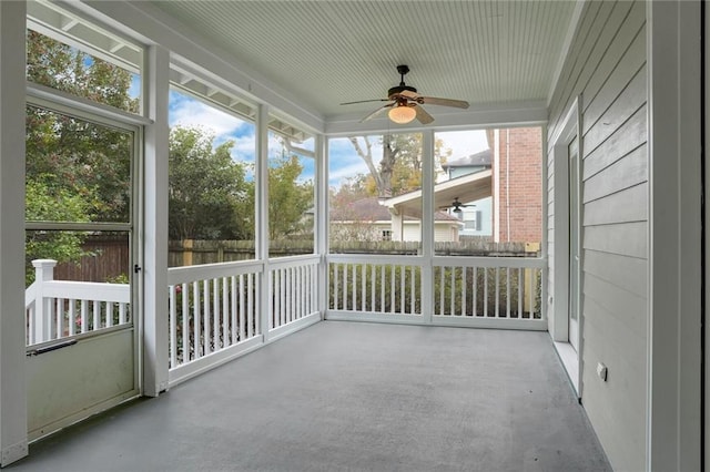 unfurnished sunroom featuring ceiling fan