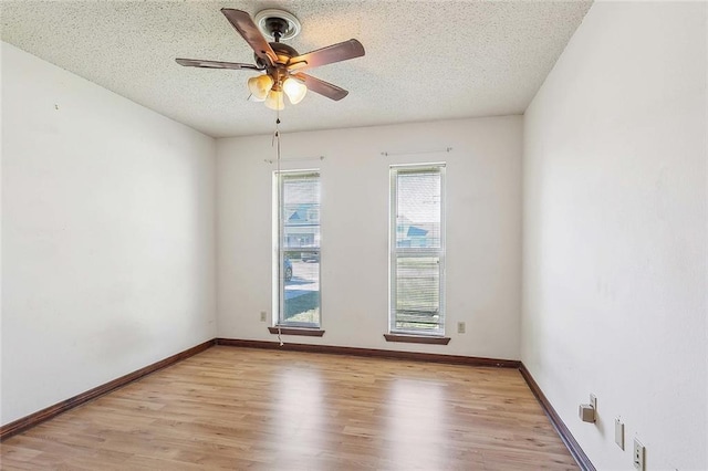 unfurnished room with ceiling fan, a textured ceiling, and light hardwood / wood-style flooring