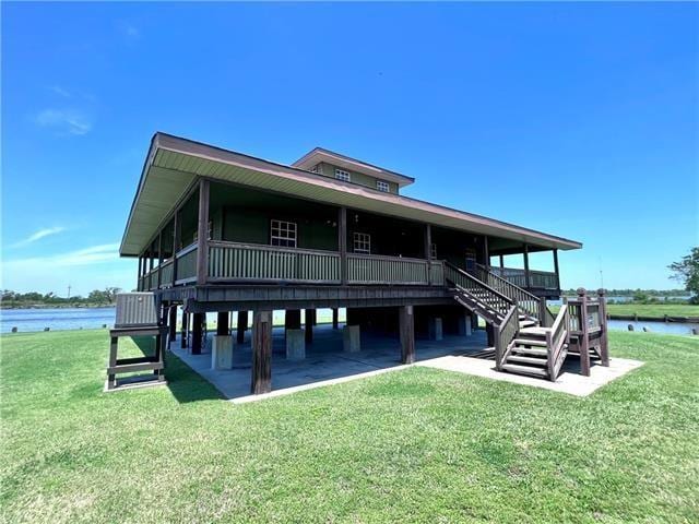 800 Anna St, Lafitte, LA 70067 - rear view of property with a lawn, a water view, and stairway