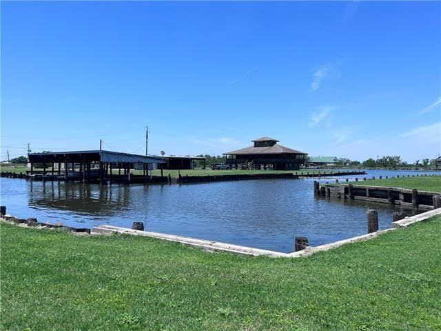800 Anna St, Lafitte, LA 70067 - dock featuring a lawn and a water view
