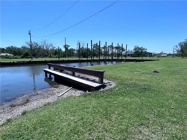 800 Anna St, Lafitte, LA 70067 - dock area with a yard and a water view