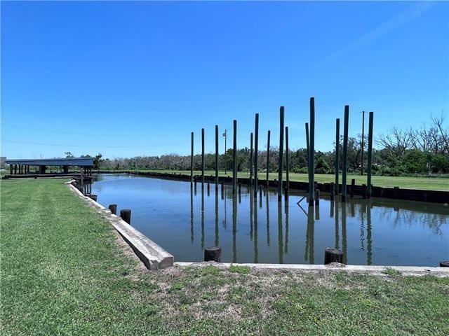 800 Anna St, Lafitte, LA 70067 - dock area featuring a water view and a lawn