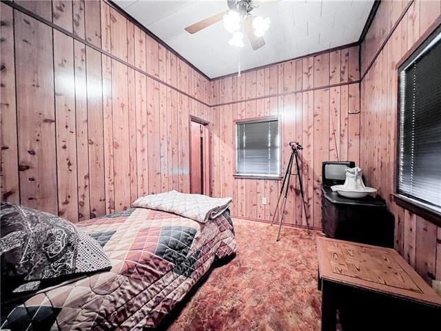 800 Anna St, Lafitte, LA 70067 - bedroom featuring wooden walls, carpet floors, and a ceiling fan