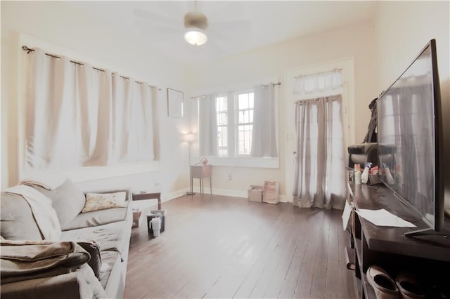 living area featuring hardwood / wood-style flooring and ceiling fan