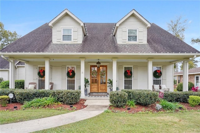 view of front of house with covered porch and a front yard