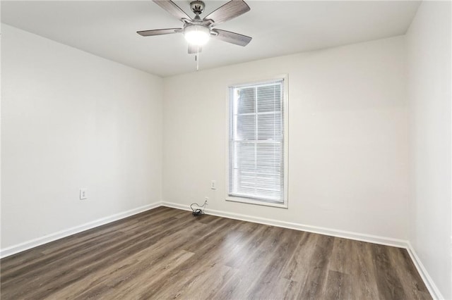 empty room with dark hardwood / wood-style flooring and ceiling fan