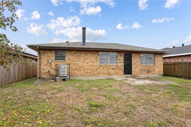 back of house with a lawn and a patio