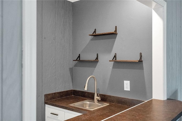 kitchen with white cabinetry and sink