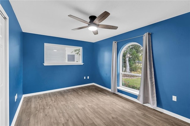 spare room with hardwood / wood-style flooring and ceiling fan