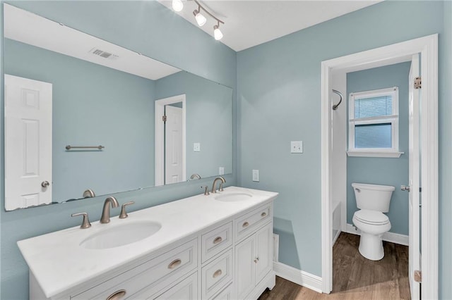 full bathroom with hardwood / wood-style floors, vanity, toilet, and bathtub / shower combination