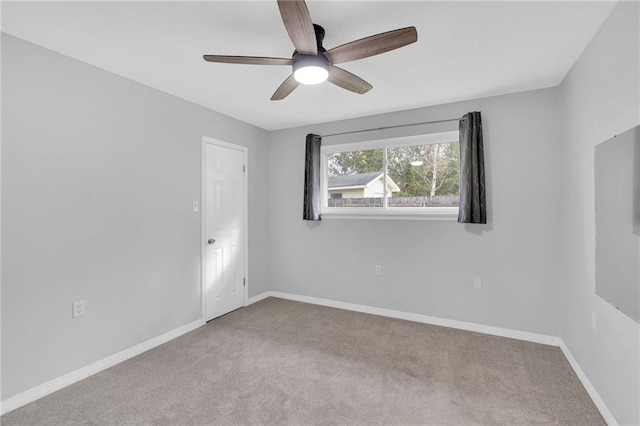 carpeted empty room featuring ceiling fan