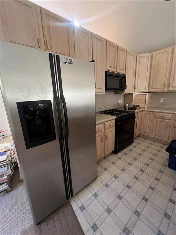 kitchen with black appliances and light brown cabinetry