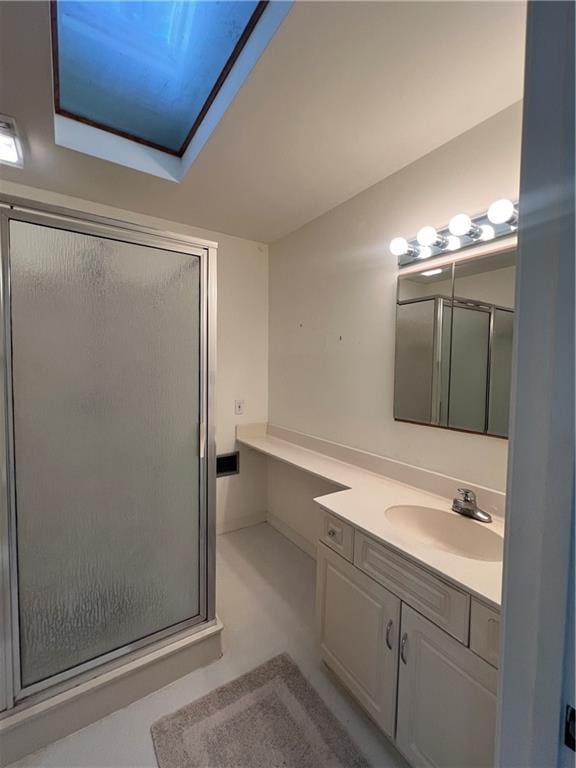 bathroom with vanity and a shower with shower door