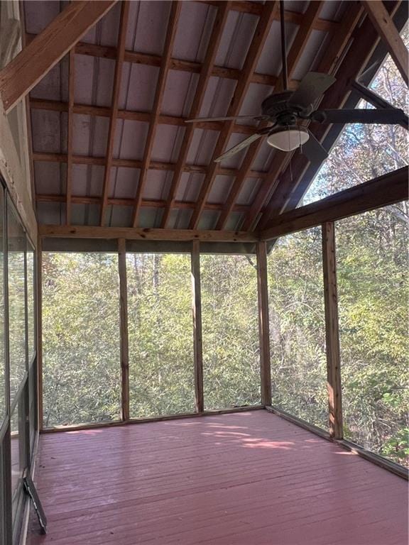 unfurnished sunroom with vaulted ceiling, ceiling fan, and plenty of natural light