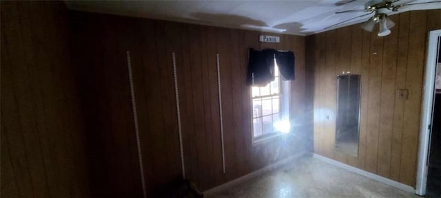 hallway featuring wooden walls