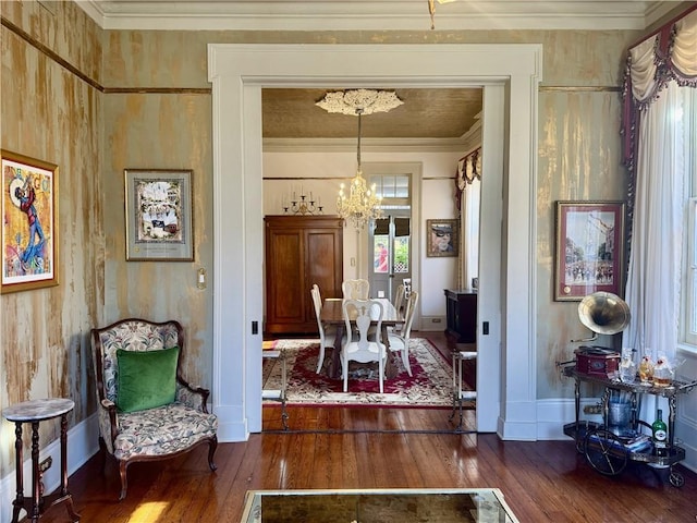 dining room with a chandelier, baseboards, crown molding, and dark wood-type flooring