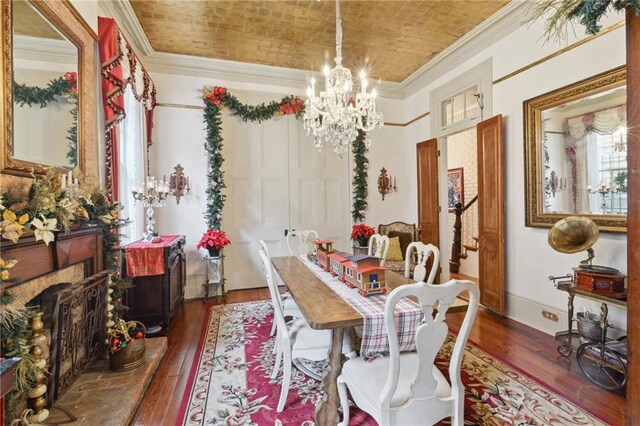 dining room featuring crown molding, brick ceiling, wood-type flooring, and a chandelier