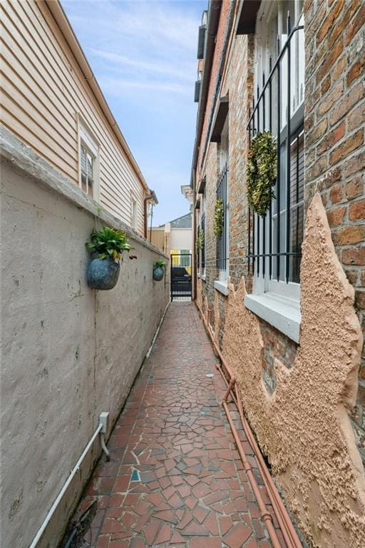 view of side of property with a gate