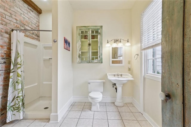 full bathroom with tile patterned flooring, a shower stall, toilet, and baseboards