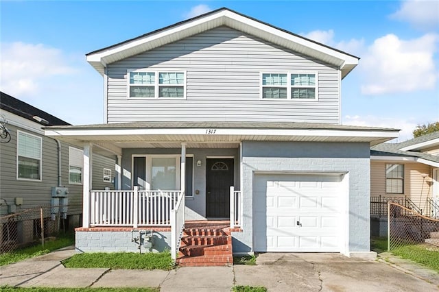 view of property featuring covered porch and a garage