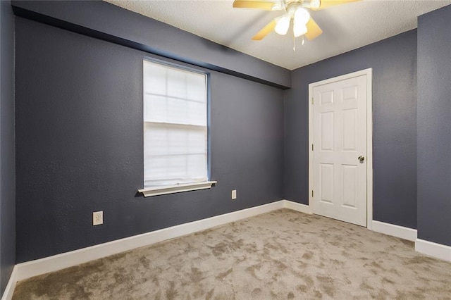 spare room with carpet flooring and ceiling fan