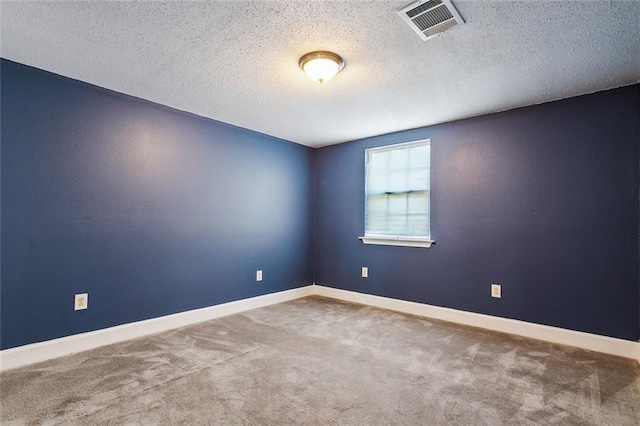 carpeted spare room featuring a textured ceiling